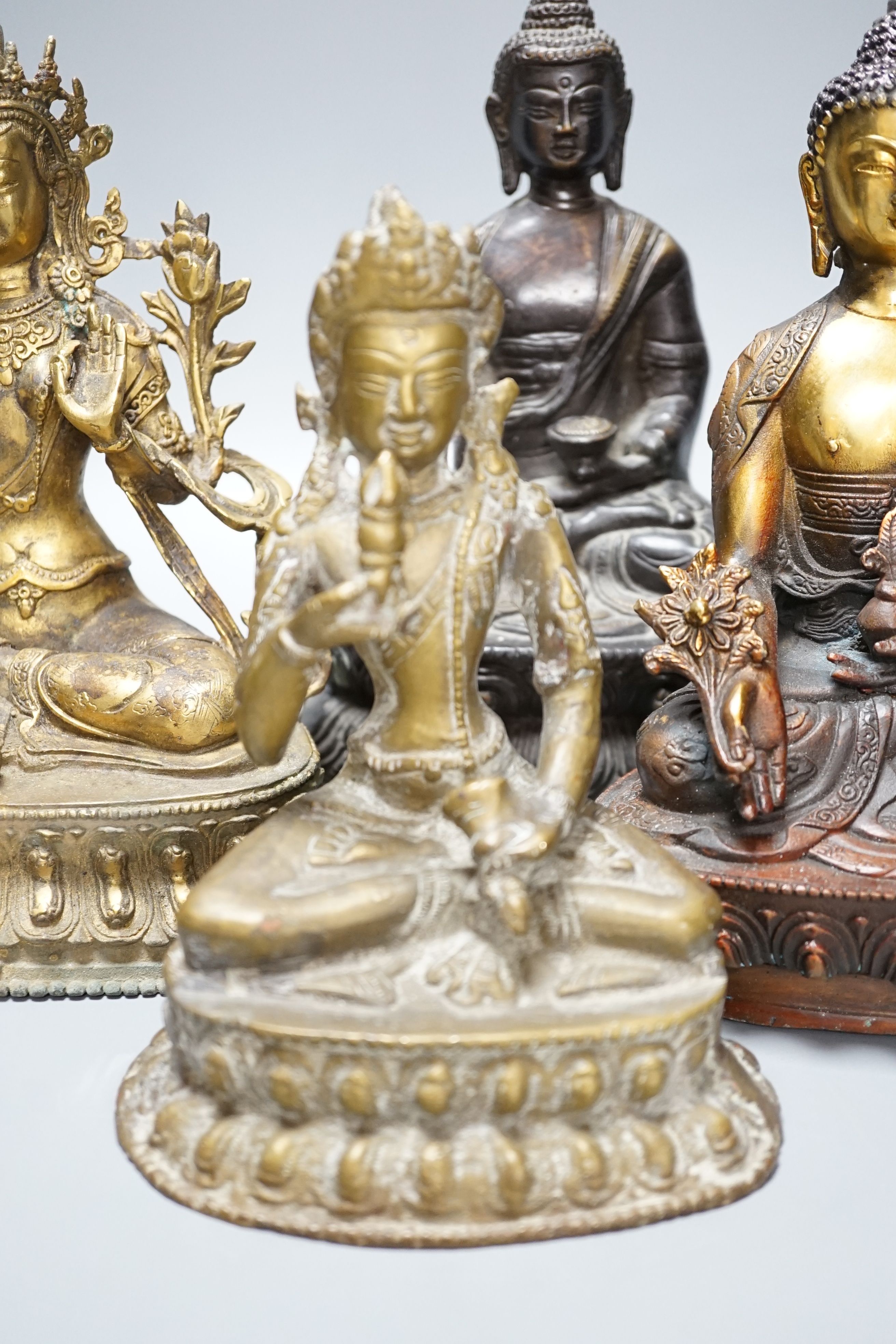 A group of five Tibetan or buddhist bronzes of deities and a Chinese bronze ‘dragon’ vase, tallest 21cm